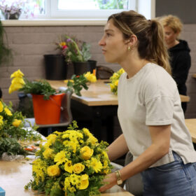 Student working on dropshape funeral arrangement