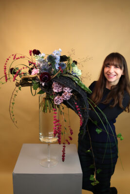 IMF Alumna Claudia Tararache with the handtied bouquet she made in class